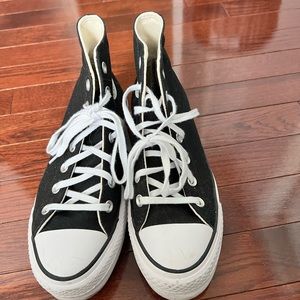 Woman’s Chuck Taylors platform sneakers in black.